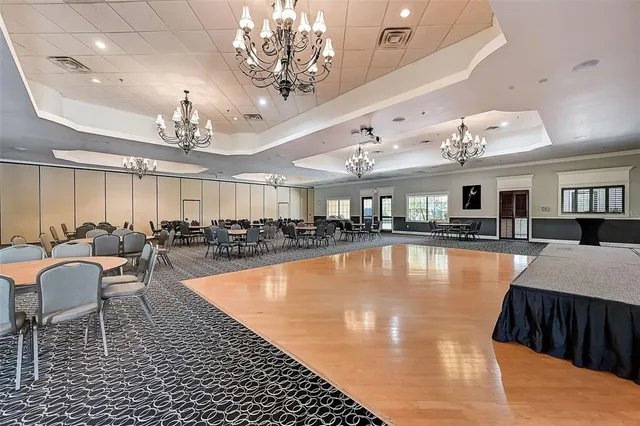 a reading room with furniture and a floor to ceiling window