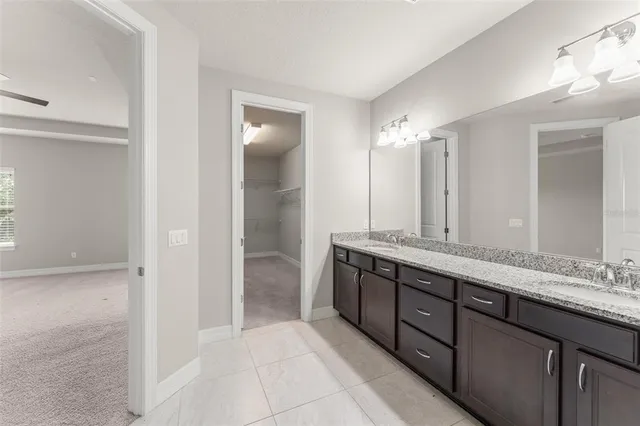 a bathroom with a double vanity sink and a mirror
