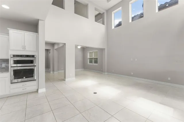 a view of an empty room with a kitchen