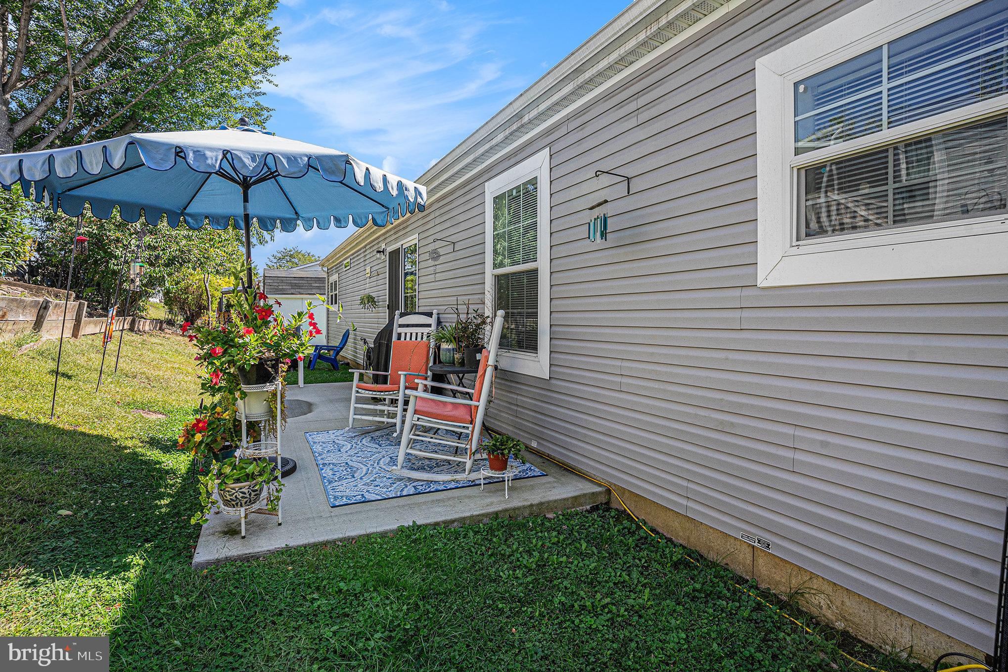906 Lakeview Drive Green Lane, PA 18054 - Photo 29 of 37 a view of a patio with a table and chairs under an umbrella