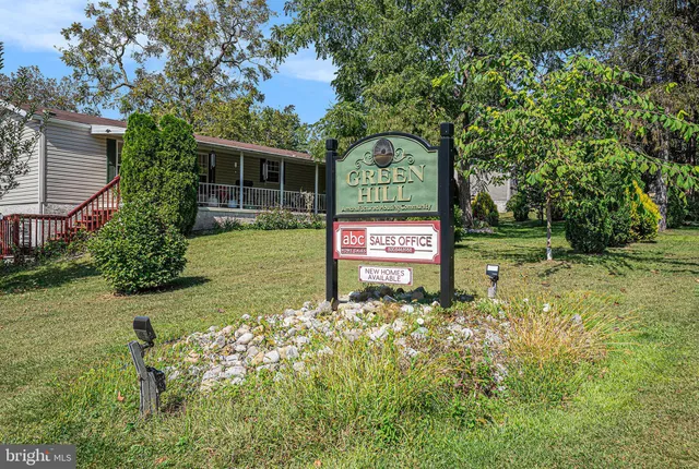 a sign of golf club on a stone wall under an umbrella