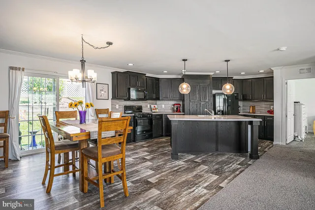 a kitchen with a table and chairs in it