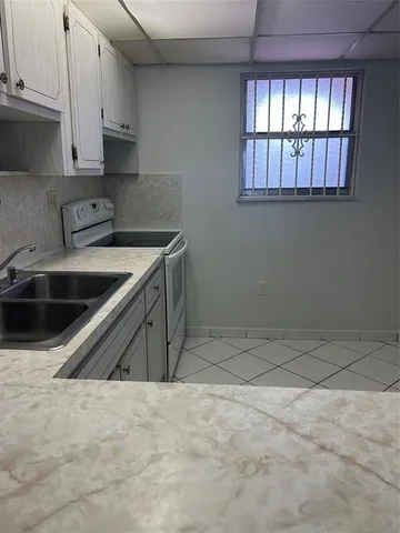 a view with a sink and cabinets