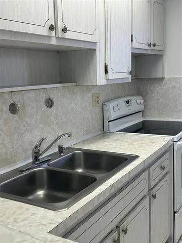 a kitchen with appliances cabinets and a sink