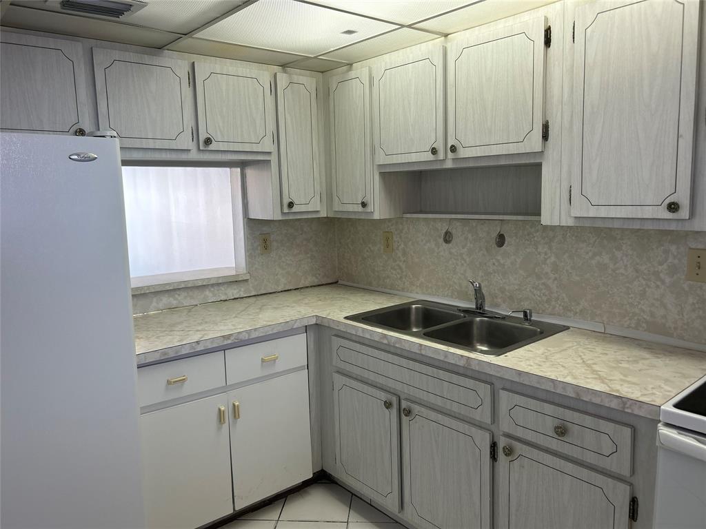 1855 West 60th Street, Unit 325 Hialeah, FL 33012 - Photo 14 of 18 a kitchen with appliances cabinets and a sink