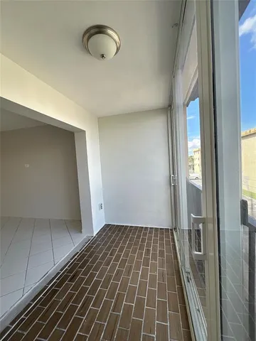 a front view of a building with a garden