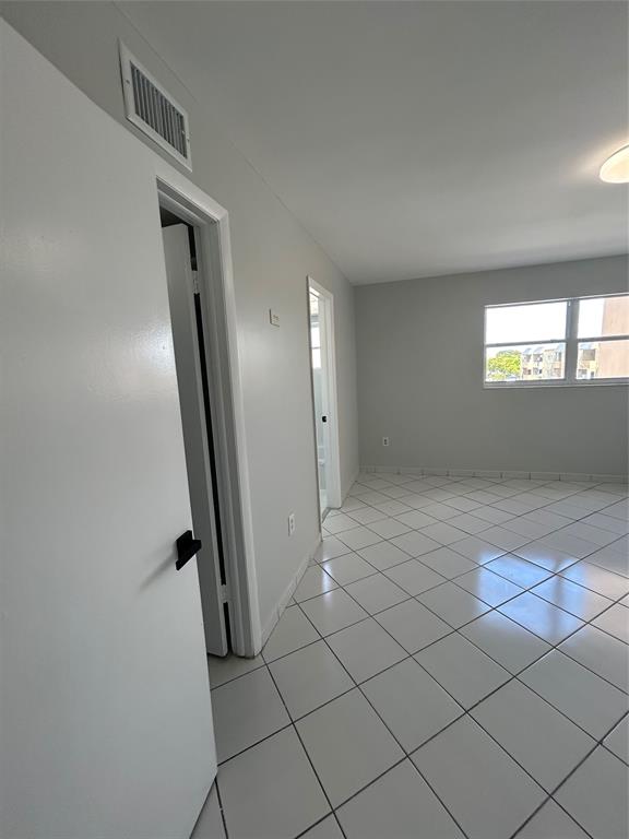 1855 West 60th Street, Unit 325 Hialeah, FL 33012 - Photo 4 of 18 an empty room with windows