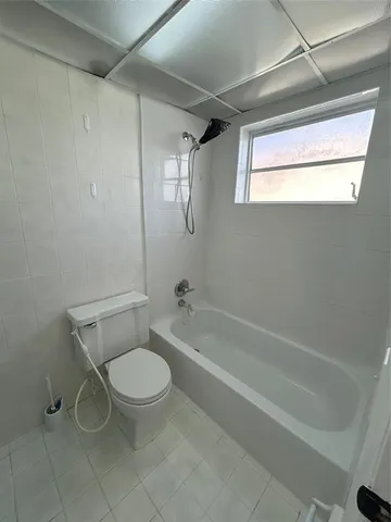 a bathroom with a toilet and a bathtub