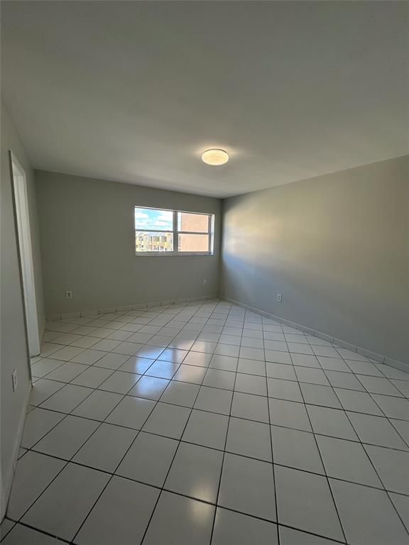 1855 West 60th Street, Unit 325 Hialeah, FL 33012 - Photo 6 of 18 a view of an empty room and window