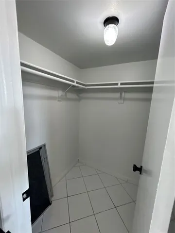 an empty room with white walls and tiles