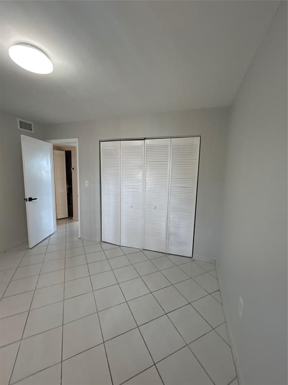 1855 West 60th Street, Unit 325 Hialeah, FL 33012 - Photo 9 of 18 en empty room with a fireplace and cabinet