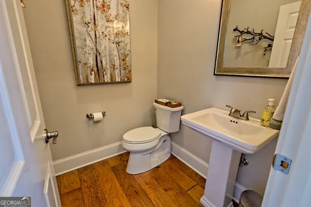 a en suite bathroom with a granite countertop sink and a mirror