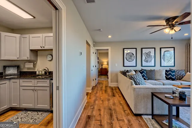 a living room with furniture wooden floor and large window