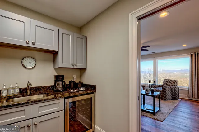 a living room with furniture ceiling fan and a large window