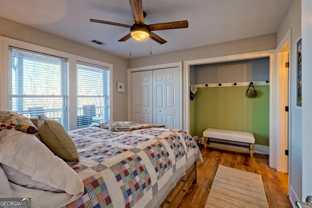 a spacious bedroom with a large bed and a large window