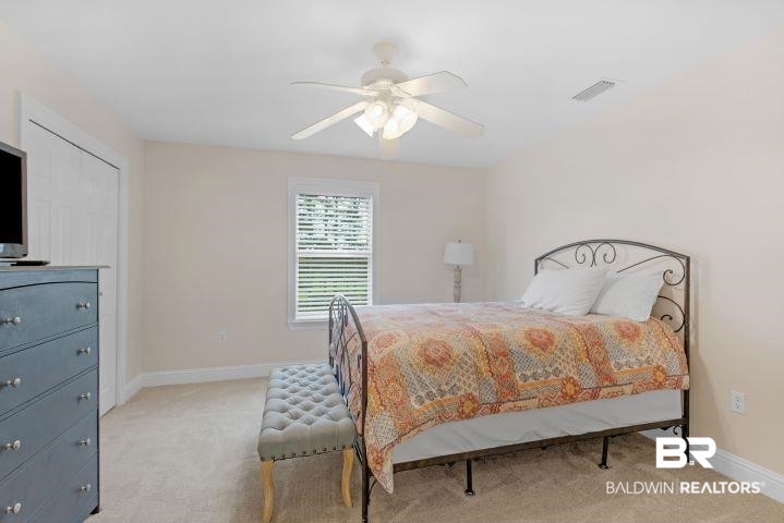 24541 Baldwin Beach Expressway Robertsdale, AL 36567 - Photo 28 of 51 Bedroom featuring baseboards, carpet flooring, visible vents, and a ceiling fan