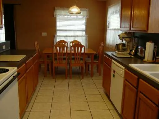 a kitchen with stainless steel appliances granite countertop a sink counter space and a window