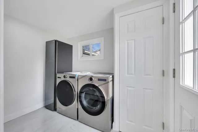 a living room with furniture a rug and a window