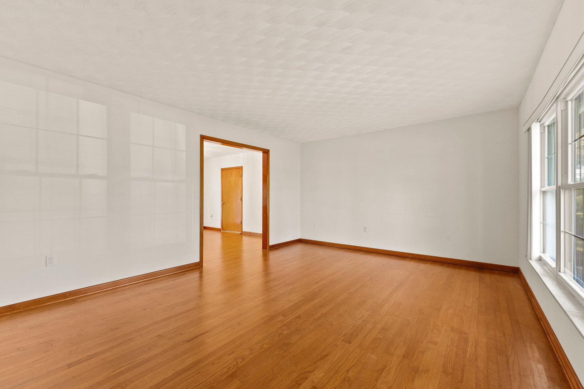 11541 Okeechobee Road Fort Pierce, FL 34945 - Photo 15 of 46 an empty room with wooden floor and windows