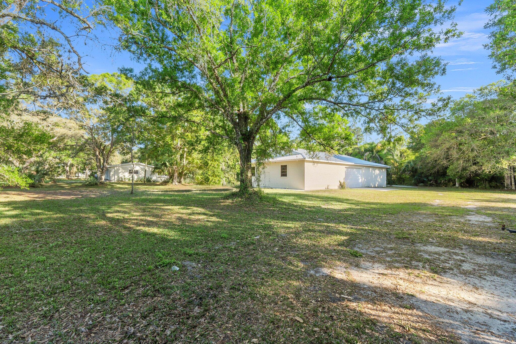 11541 Okeechobee Road Fort Pierce, FL 34945 - Photo 30 of 46 a view of a trees with a yard