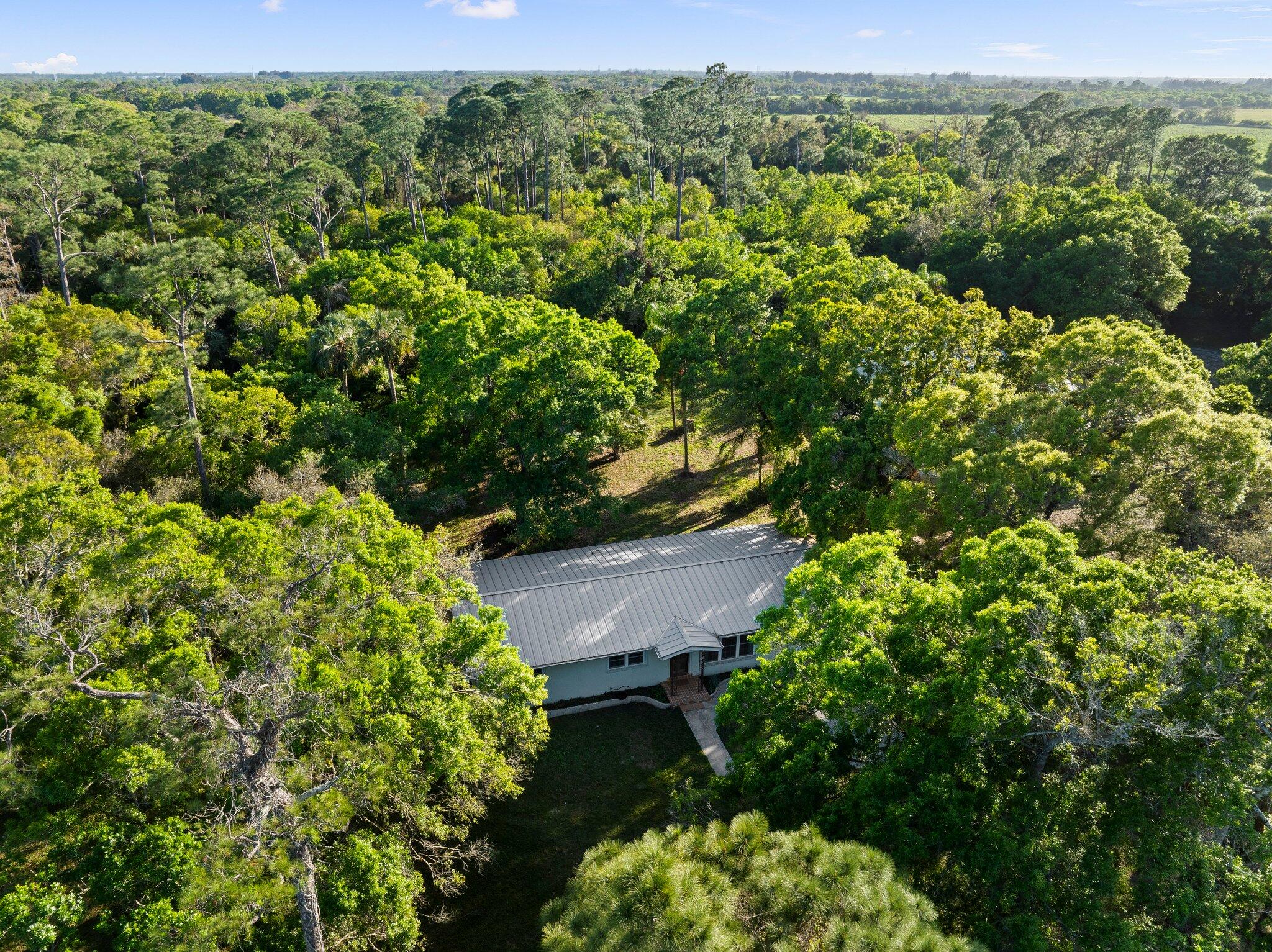 11541 Okeechobee Road Fort Pierce, FL 34945 - Photo 42 of 46 an aerial view of a house with a yard