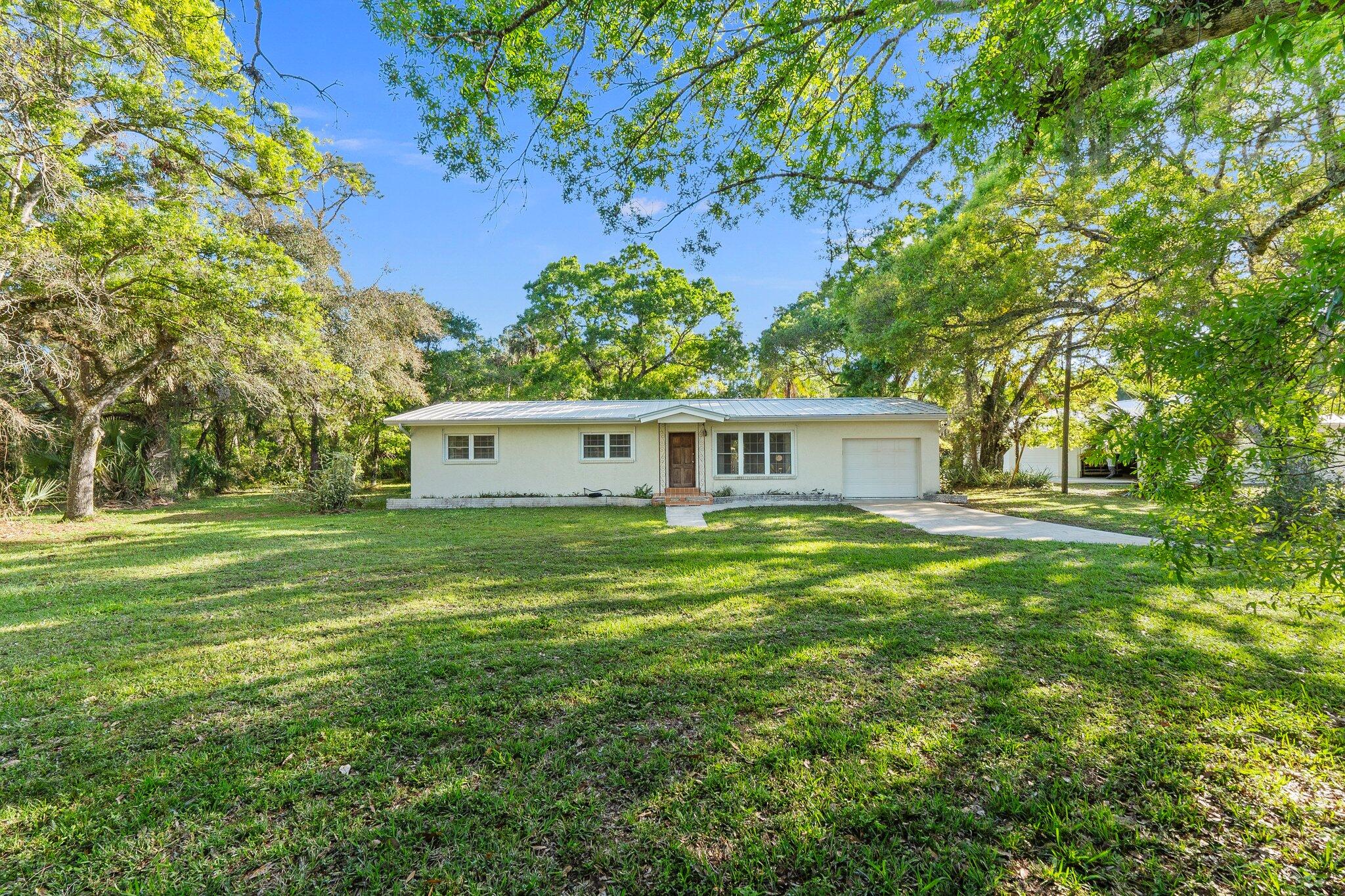 11541 Okeechobee Road Fort Pierce, FL 34945 - Photo 5 of 46 a view of a house with a yard
