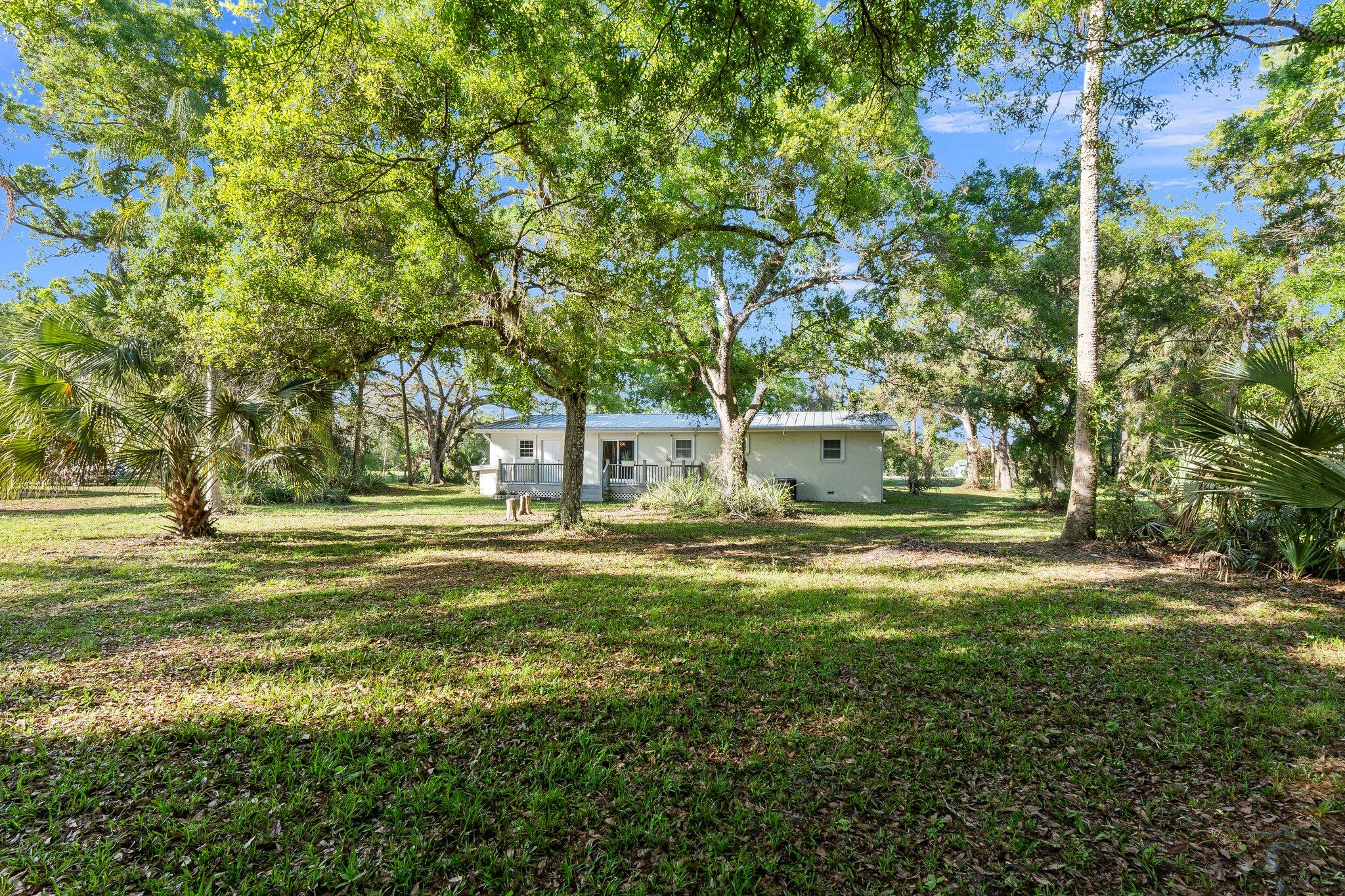 11541 Okeechobee Road Fort Pierce, FL 34945 - Photo 6 of 46 a view of a fountain in the middle of a yard