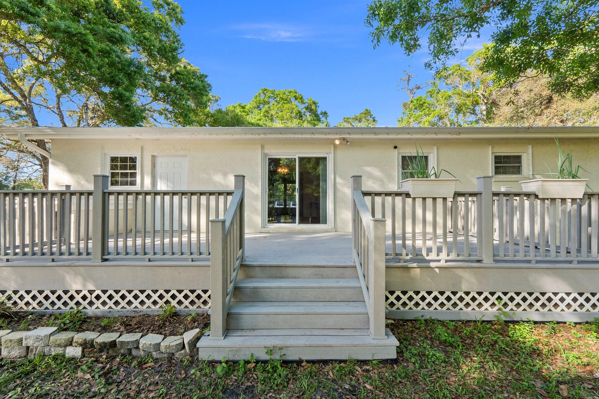 11541 Okeechobee Road Fort Pierce, FL 34945 - Photo 9 of 46 a view of a house with a wooden fence