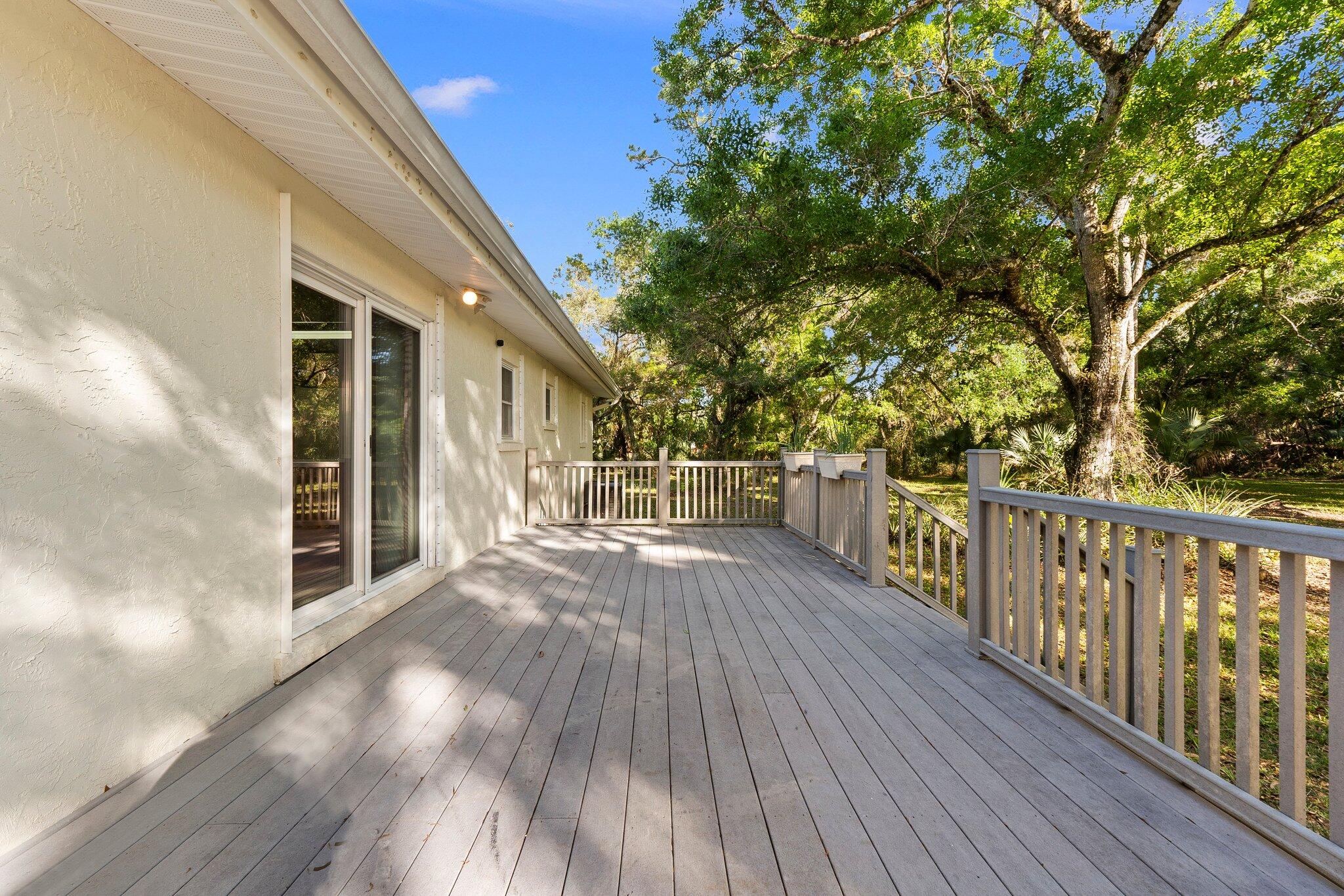 11541 Okeechobee Road Fort Pierce, FL 34945 - Photo 10 of 46 a view of a balcony with wooden floor and fence