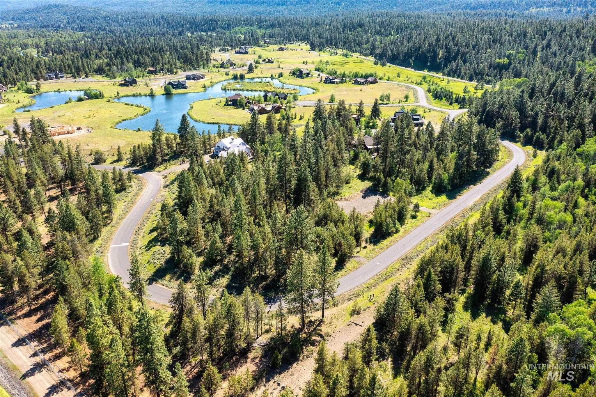 110 Fawnlilly Drive McCall, ID 83638 - Photo 2 of 27 Drone / aerial view of a heavily wooded area and a nearby body of water