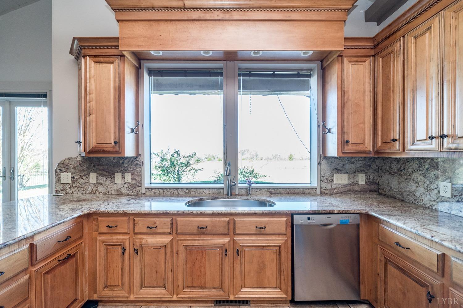 11261 Forest Road Forest, VA 24551 - Photo 21 of 99 a kitchen with stainless steel appliances granite countertop a sink a counter space and a window