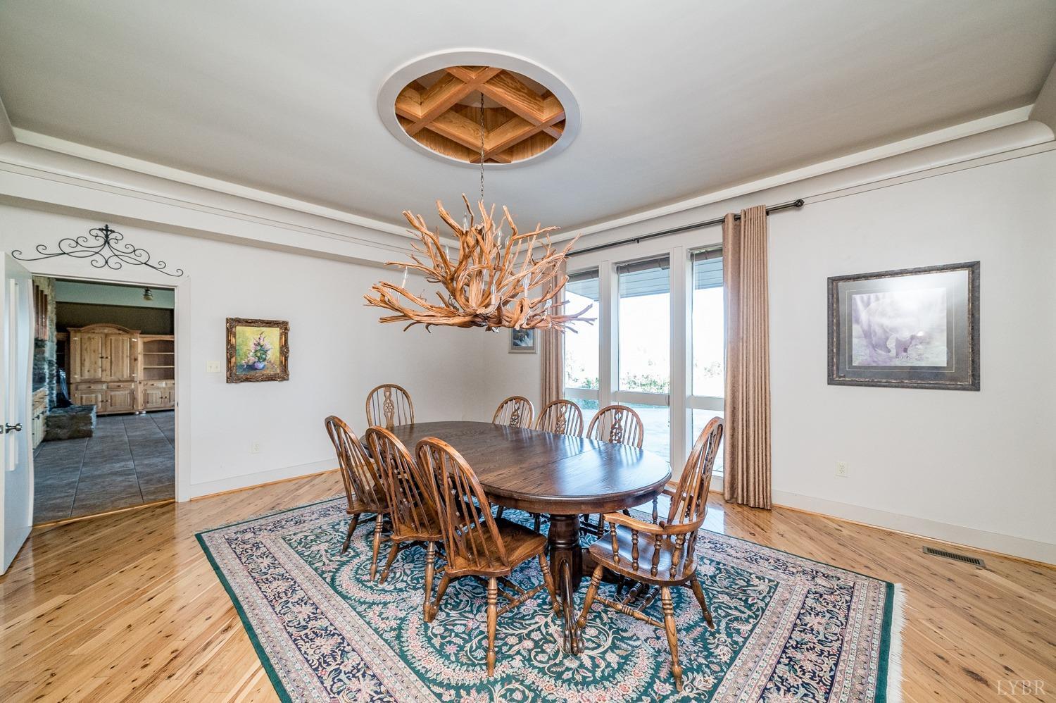 11261 Forest Road Forest, VA 24551 - Photo 31 of 99 a dining room with furniture a rug and a chandelier