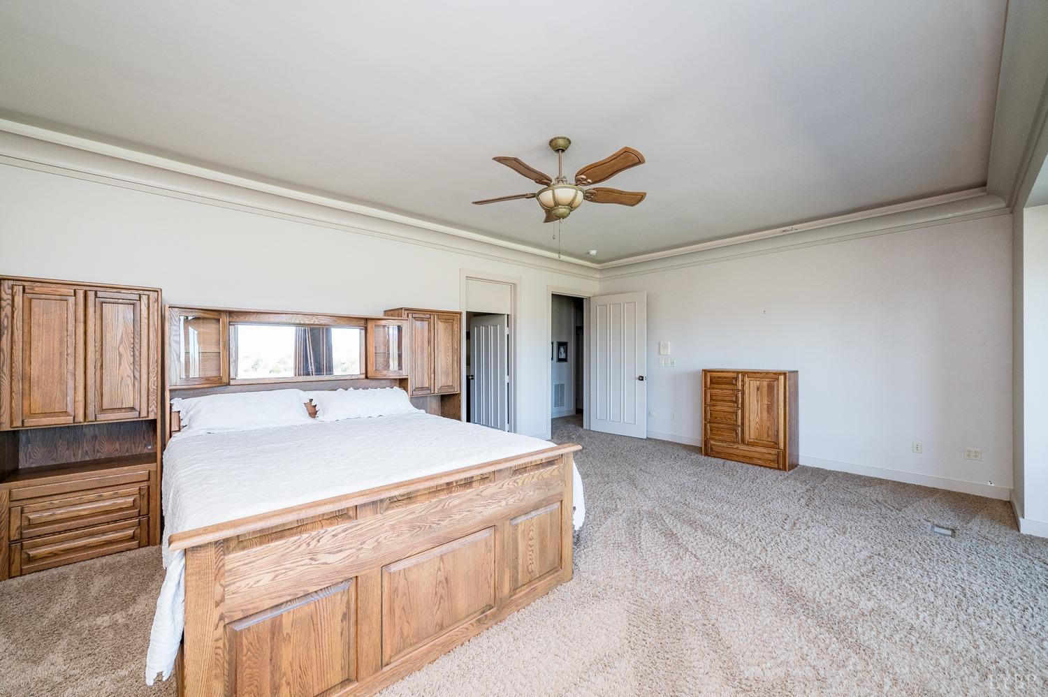 11261 Forest Road Forest, VA 24551 - Photo 39 of 99 a spacious bedroom with a bed and a chandelier