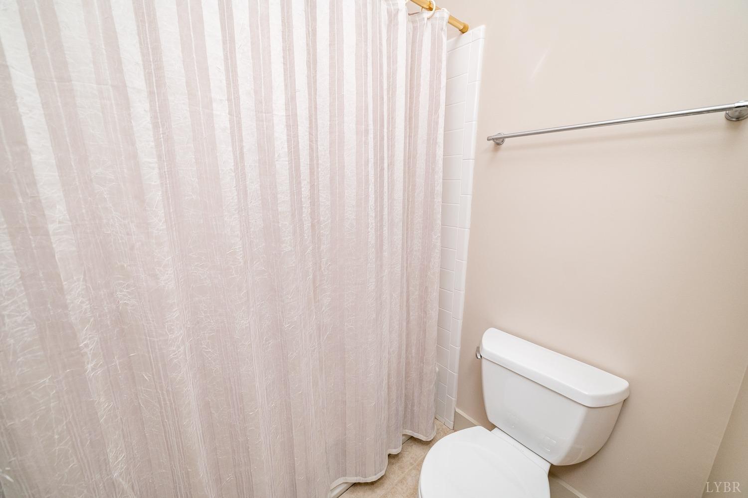 11261 Forest Road Forest, VA 24551 - Photo 60 of 99 a white toilet sitting next to a shower curtain