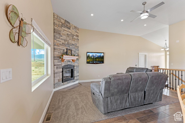 19502 South Olson Road Downey, ID 83234 - Photo 8 of 64 Carpeted living room with lofted ceiling, a stone fireplace, ceiling fan, and recessed lighting