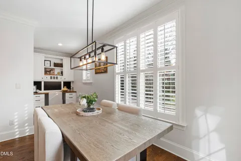 a spacious bedroom with a bed and a chandelier