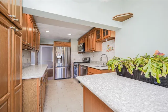 a large kitchen with stainless steel appliances granite countertop lots of counter top space