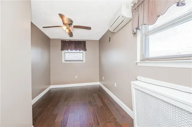a view of entryway with a window and wooden floor