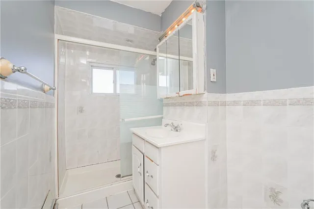 a bathroom with a sink vanity and a mirror