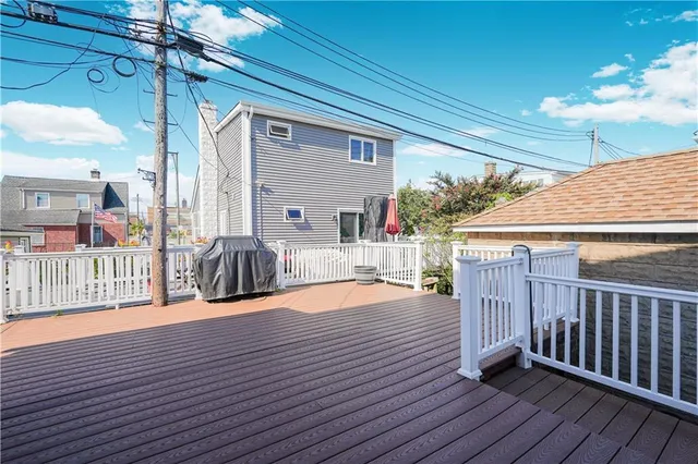 a view of a house with wooden deck