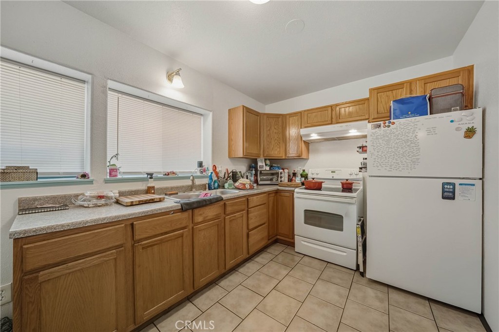 14840 Valley Clearlake, CA 95422 - Photo 29 of 36 a kitchen with a white cabinets and white appliances