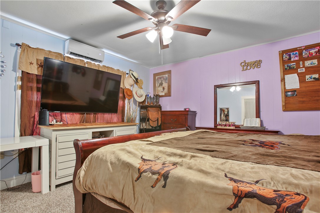 2119 Summer Avenue Waco, TX 76708 - Photo 17 of 32 a bedroom with a bed and a flat screen tv