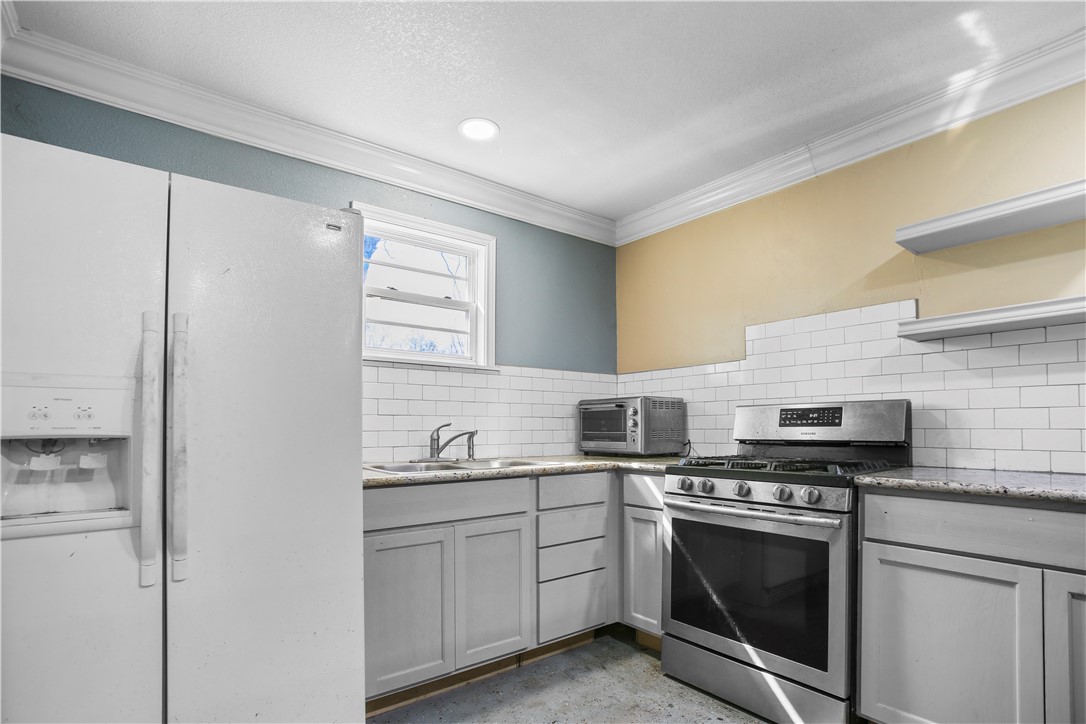 2119 Summer Avenue Waco, TX 76708 - Photo 27 of 32 a kitchen with cabinets stainless steel appliances and sink
