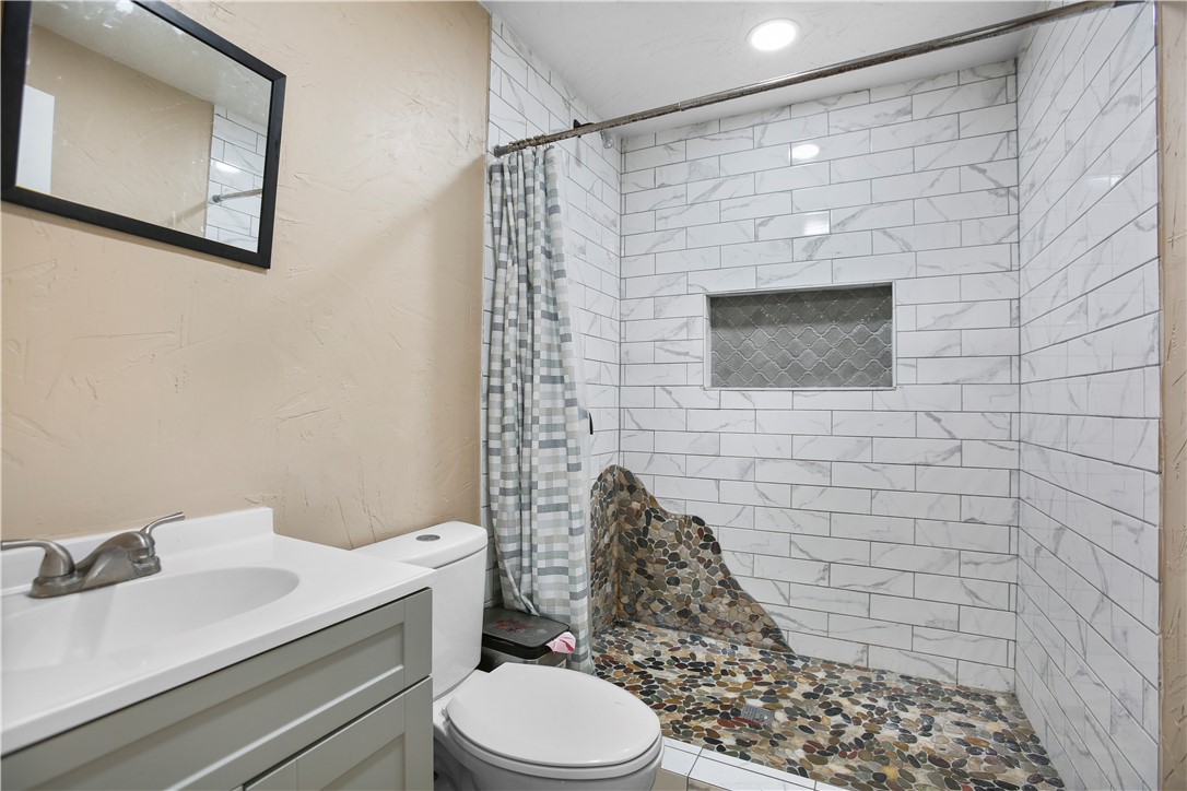 2119 Summer Avenue Waco, TX 76708 - Photo 31 of 32 a bathroom with a sink toilet and shower