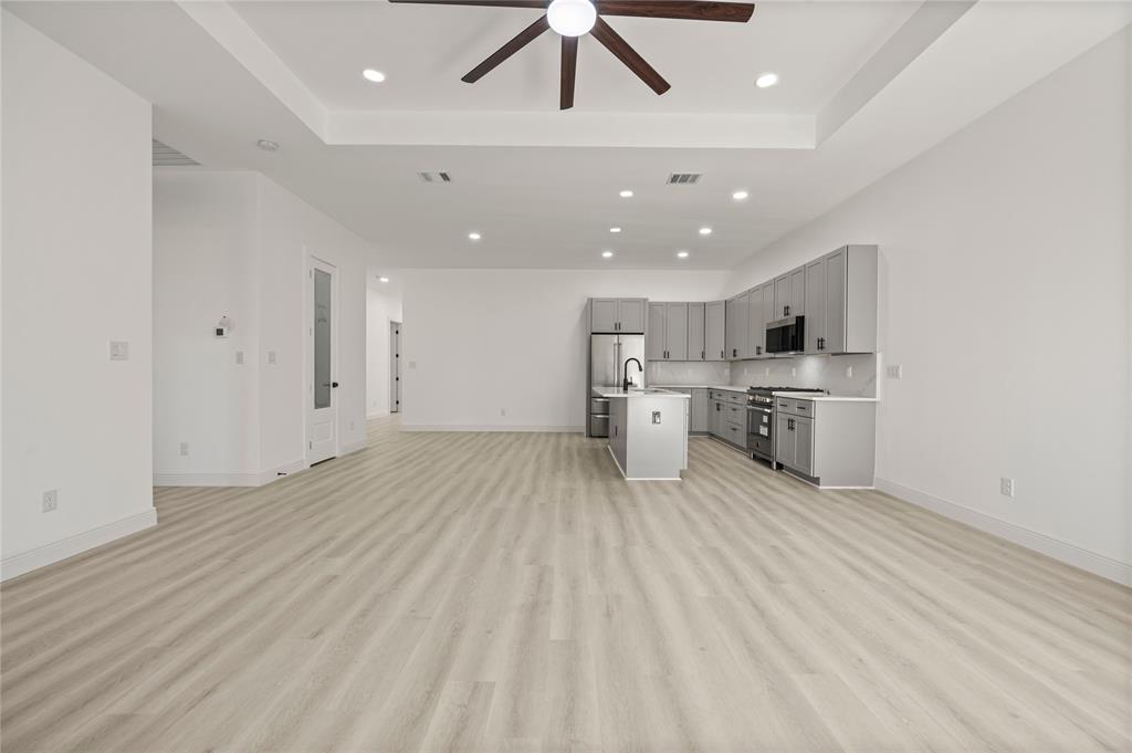 3323 Reed Lane Dallas, TX 75215 - Photo 13 of 33 a view of kitchen with stainless steel appliances refrigerator stove microwave and cabinets