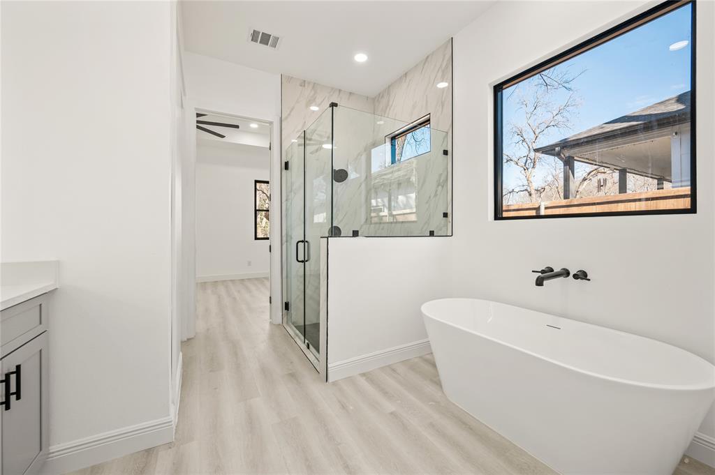 3323 Reed Lane Dallas, TX 75215 - Photo 19 of 33 a bathroom with a bathtub and shower
