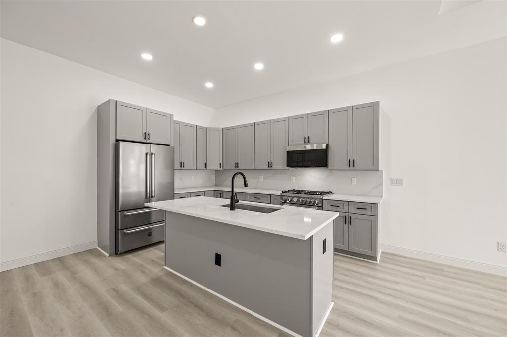 3323 Reed Lane Dallas, TX 75215 - Photo 6 of 33 a kitchen with stainless steel appliances granite countertop a sink stove and refrigerator