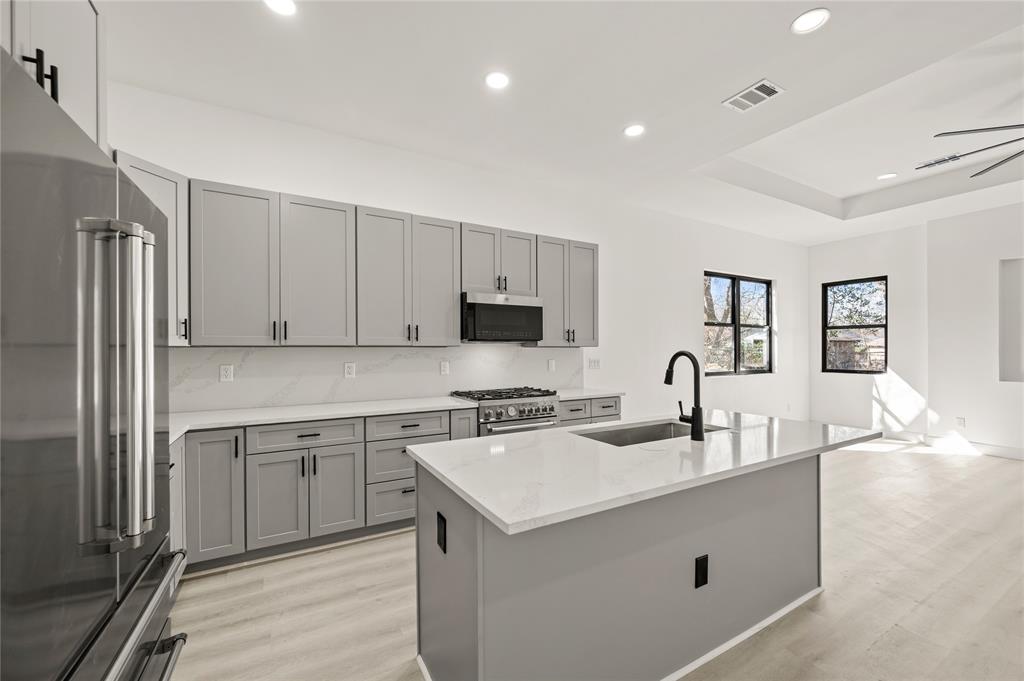 3323 Reed Lane Dallas, TX 75215 - Photo 8 of 33 a kitchen with a sink stove and refrigerator