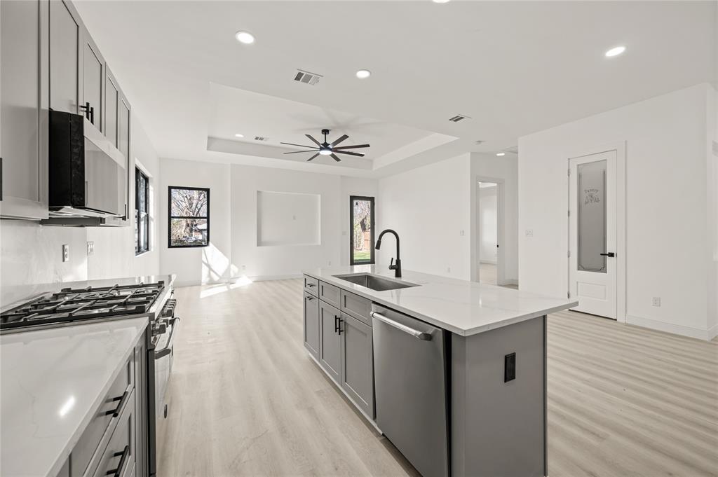 3323 Reed Lane Dallas, TX 75215 - Photo 9 of 33 a kitchen with a sink stove and microwave