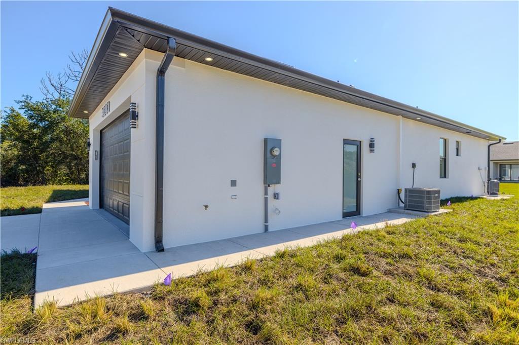 3303 24th Street Southwest Lehigh Acres, FL 33976 - Photo 23 of 25 a front view of a house with a yard
